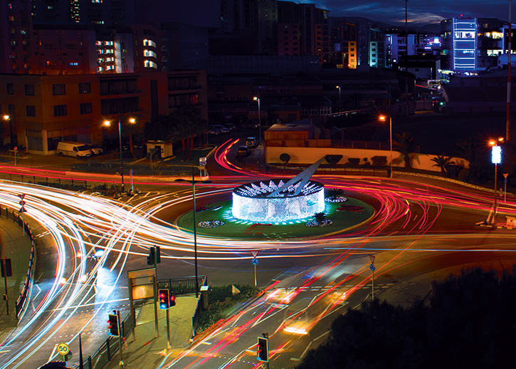 Long exposure light lines racing around a round about