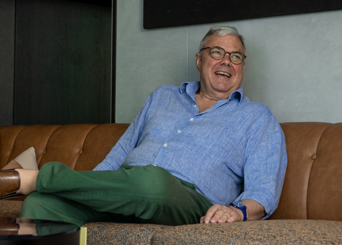 President George Bassadone sat laughing