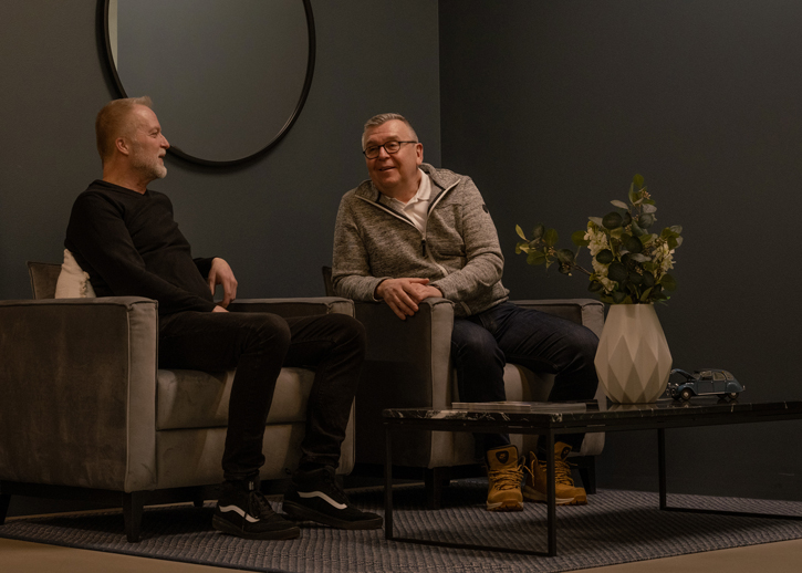 Two people sat having a conversation in a casual setting 